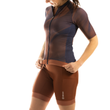 Person wearing a brown and blue cycling outfit
